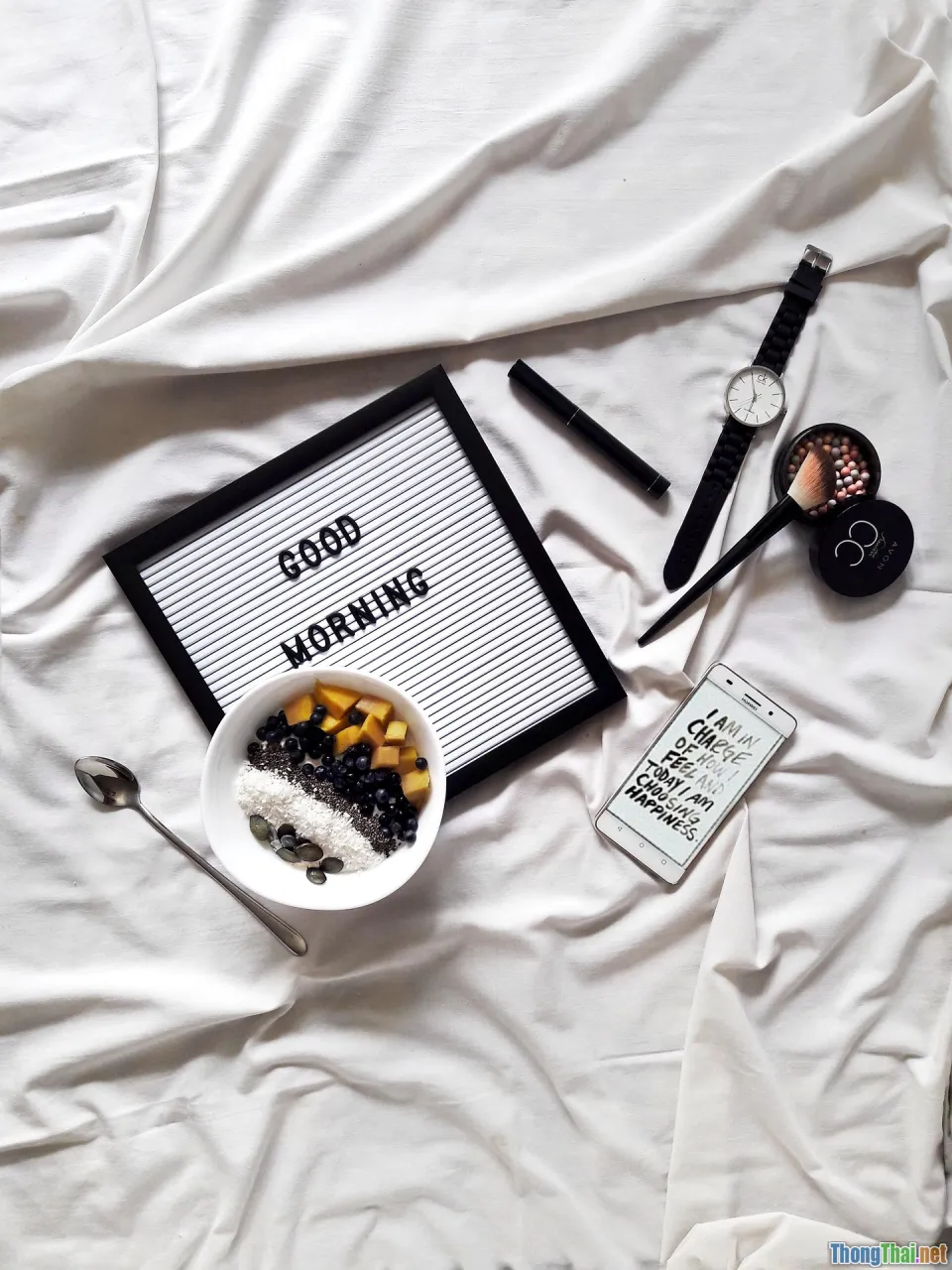 smartphone, water bottle, makeup brushes