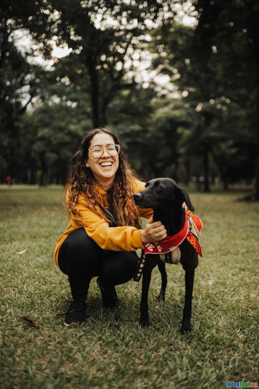 happy woman petting dog, mental health, smiling